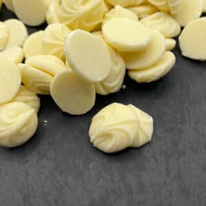White chocolate buds on a black background