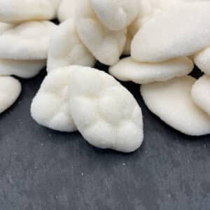 pile of white cloud candy on a black background