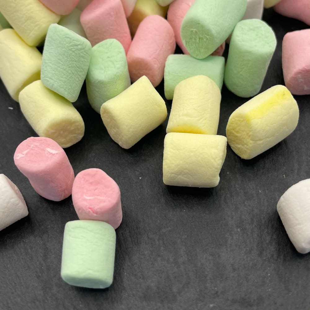 colourful mini marshmallows on a grey stone background