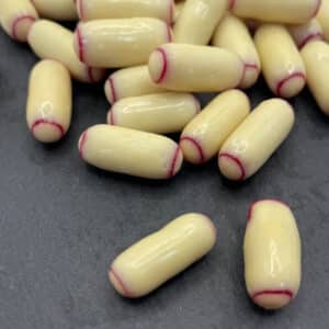 loose pile of white chocolate coated raspberry bullets